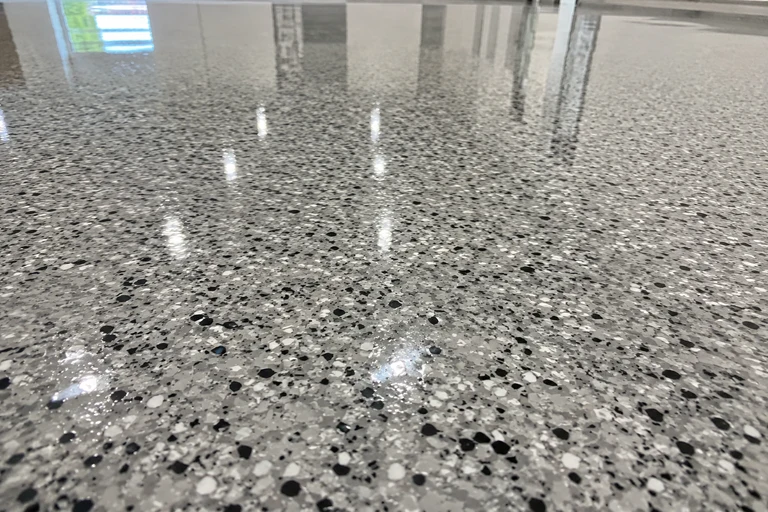Polyaspartic topcoat application on a garage floor by 1Day Garage Epoxy
